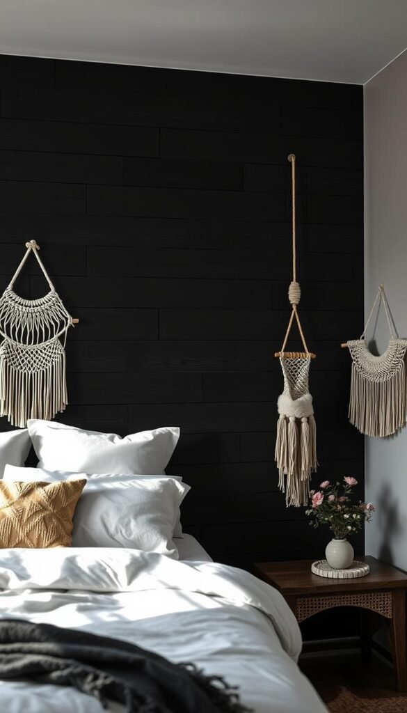 A moody, rustic bedroom feature wall with sleek black painted wood planks arranged in a geometric pattern. The planks are accented with macrame wall hangings in neutral tones, adding a touch of organic texture and warmth. Soft, directional lighting from above casts dramatic shadows, creating depth and contrast. The overall atmosphere is cozy, sophisticated, and on-trend.
