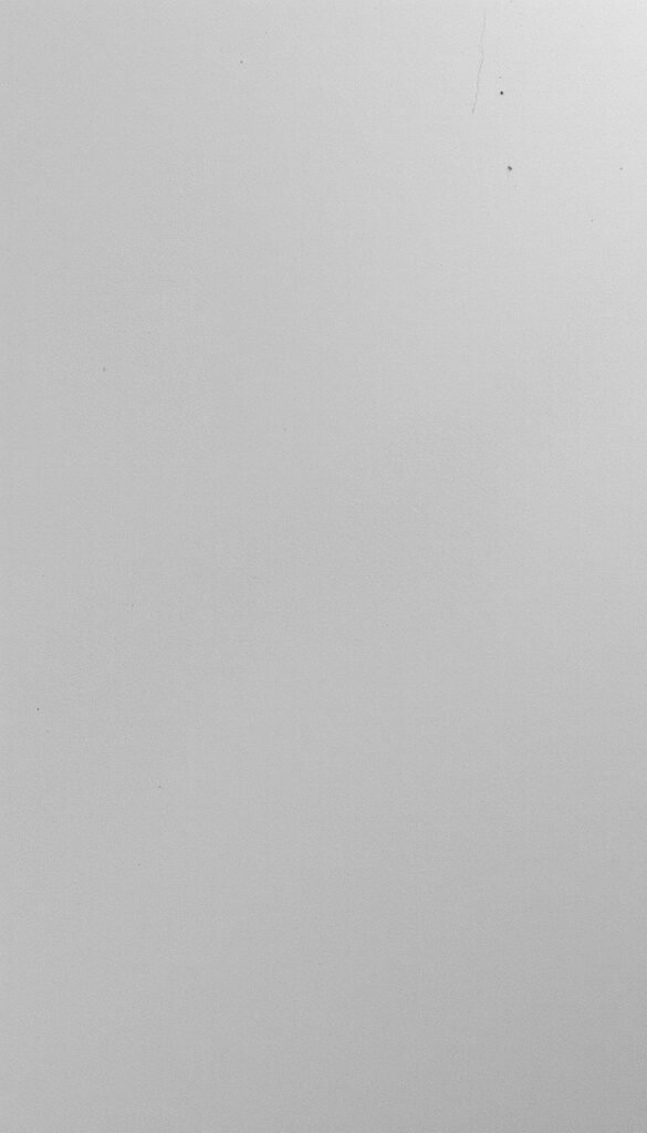 A minimalist, modern concrete texture wallpaper fills the frame, showcasing a sleek, gray-toned surface with subtle variations and a matte finish. The lighting is soft and diffused, creating a sense of depth and dimension. The camera angle is slightly elevated, allowing the viewer to appreciate the textural details and the overall minimalist aesthetic. The atmosphere is one of understated elegance, where the concrete's natural beauty takes center stage, creating a sophisticated and calming ambiance.