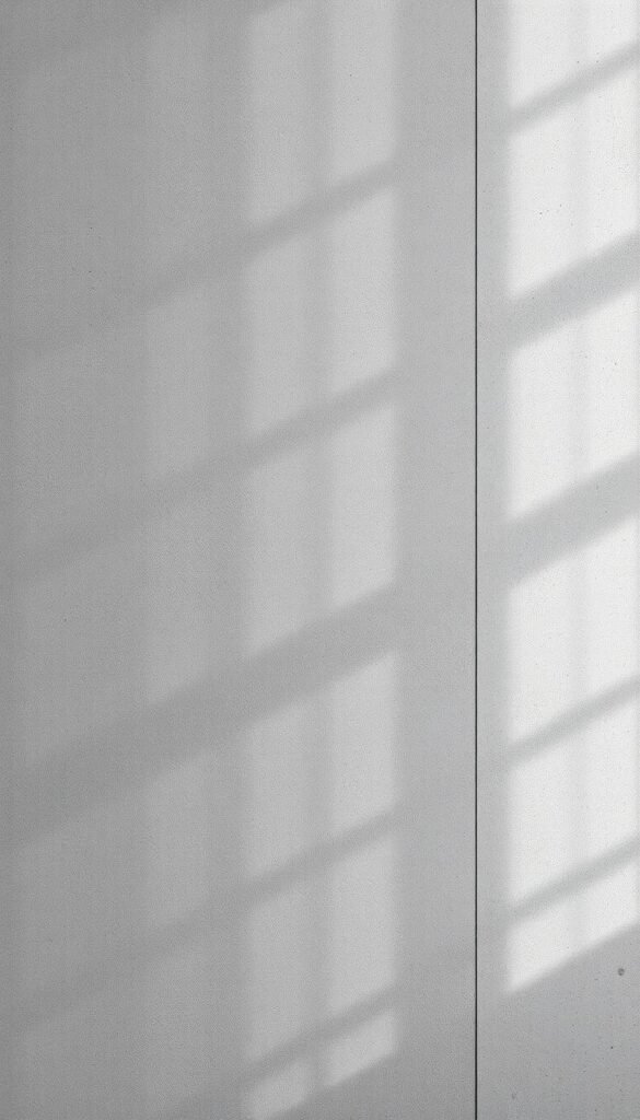 a high-resolution, photorealistic image of an industrial concrete effect wallpaper design, with a modern, urban aesthetic. The wallpaper features a textured, gritty concrete surface with subtle variations in shading and tone, creating a sense of depth and dimension. The design has a minimal, geometric pattern that adds visual interest without being overpowering. The lighting is soft and diffused, casting gentle shadows that accentuate the texture of the concrete. The overall mood is one of sophistication, with a touch of industrial chic that would complement a modern, urban bedroom interior.