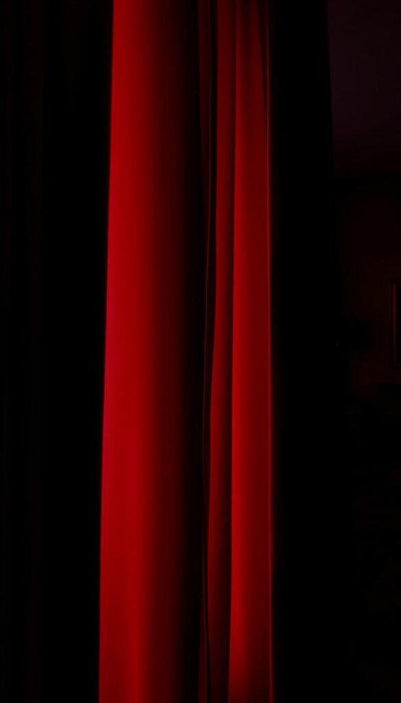 A luxurious, deep-burgundy velvet curtain, its plush folds cascading down in rich, sensuous waves. The curtain is backlit, casting a warm, inviting glow that envelops the viewer. The lighting is soft and dramatic, creating an air of mystery and serenity. In the background, a dimly lit bedroom, its walls painted in a deep, moody hue, the curtain serving as the focal point, commanding attention and drawing the eye inward. The scene evokes a sense of opulence, comfort, and psychological depth, perfectly capturing the essence of a dramatic, velvet-draped bedroom.